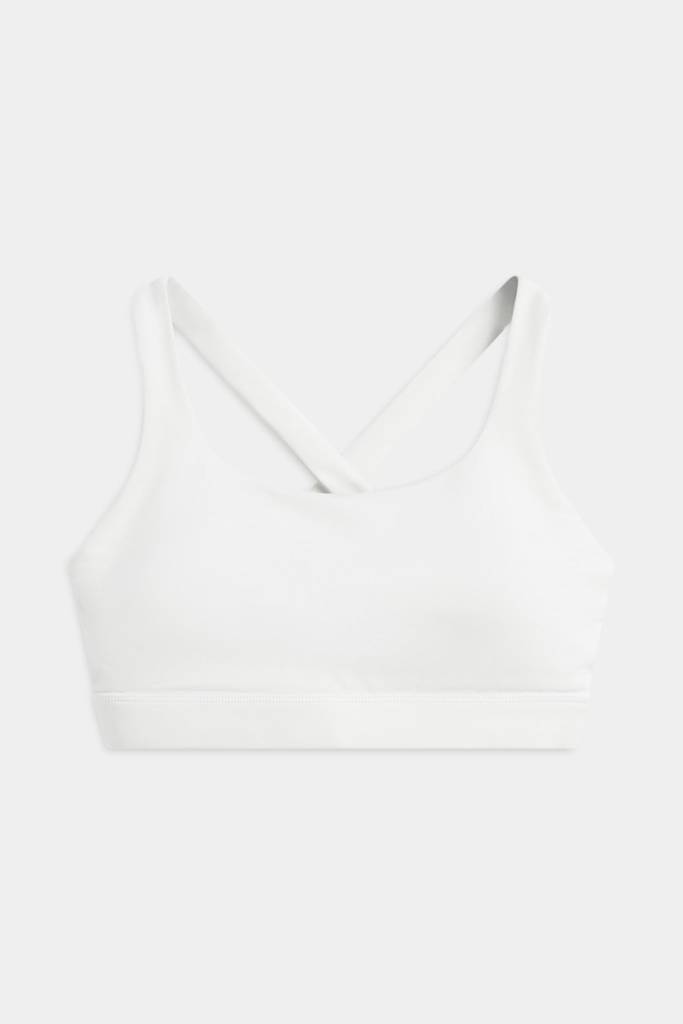 Front view of the white CASPARA Cloudform crossback sports bra on a neutral background.